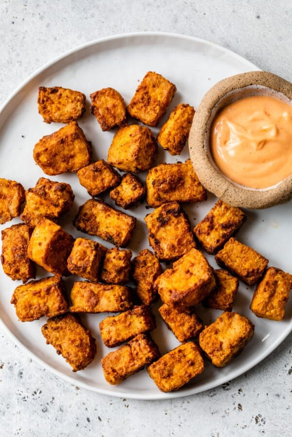 air fryer tofu on a plate with dipping sauce on the side