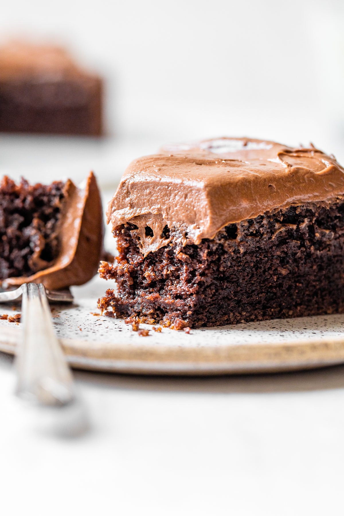 a slice of chocolate cake with a bite taken out of it