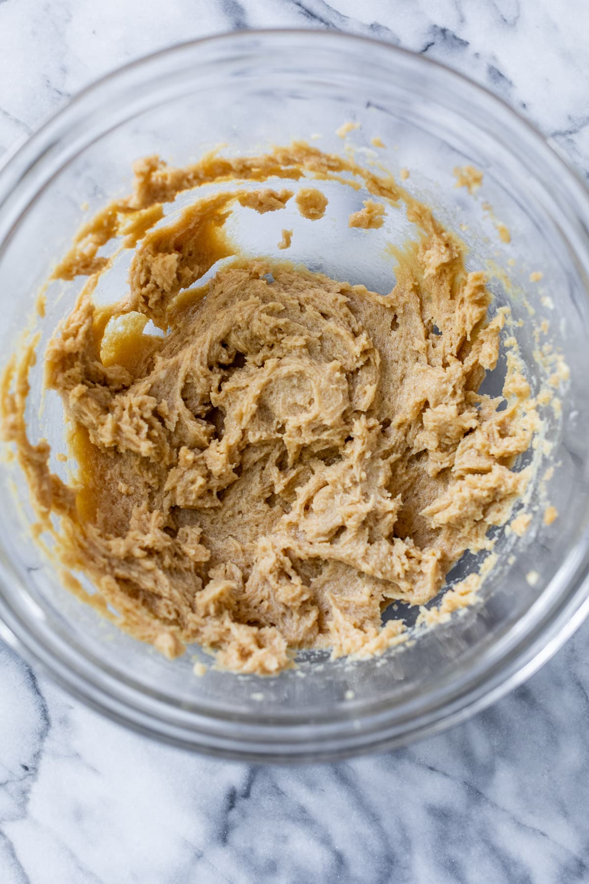 the wet batter for apple oatmeal cookies in a glass bowl.