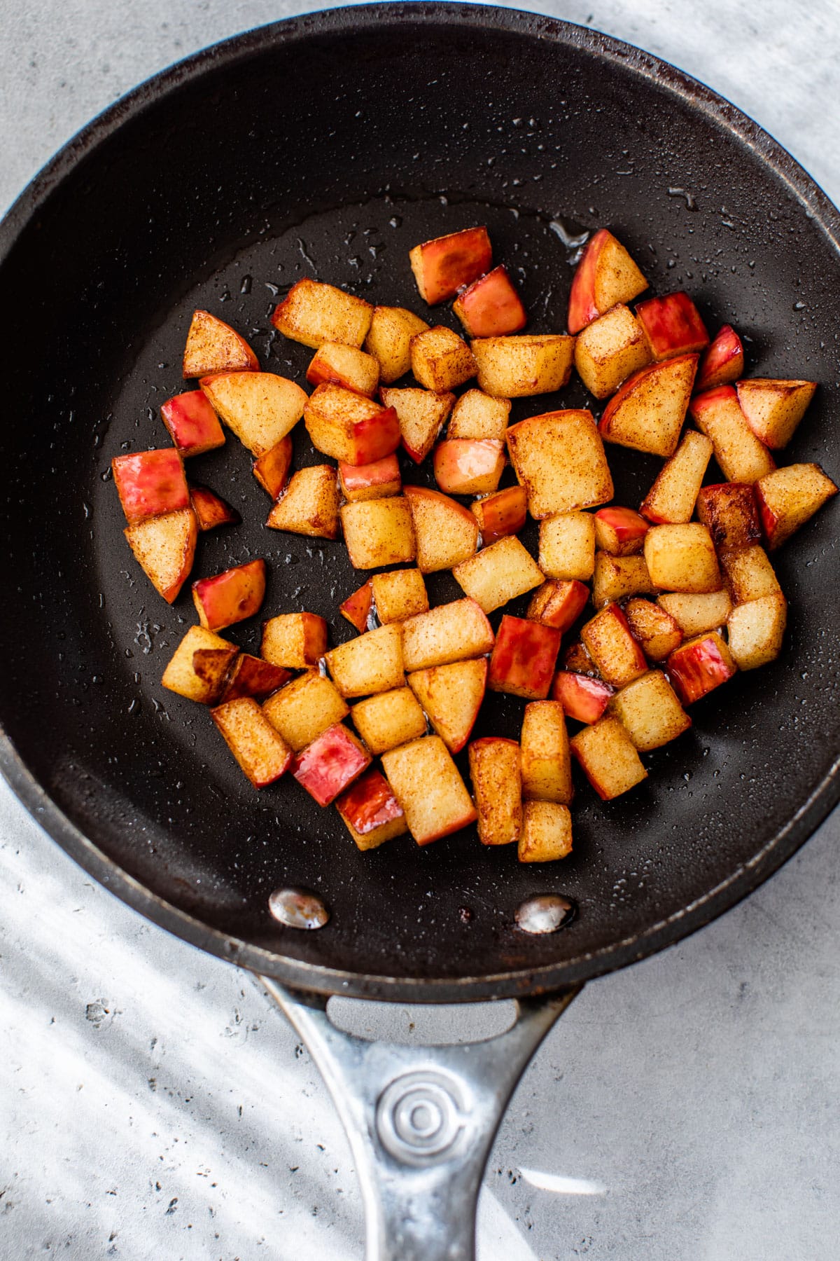 a skillet with diced cooked apples in it
