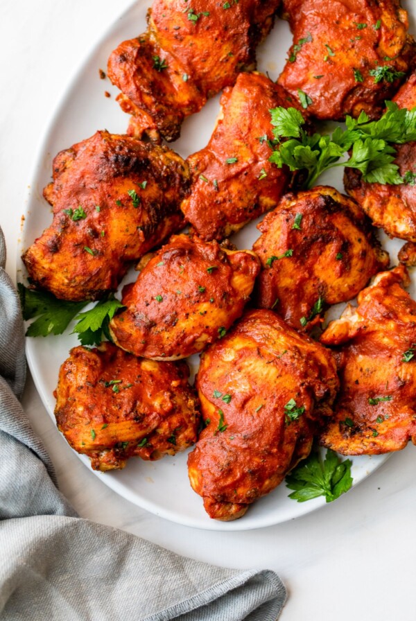 several bbq chicken thighs on a platter