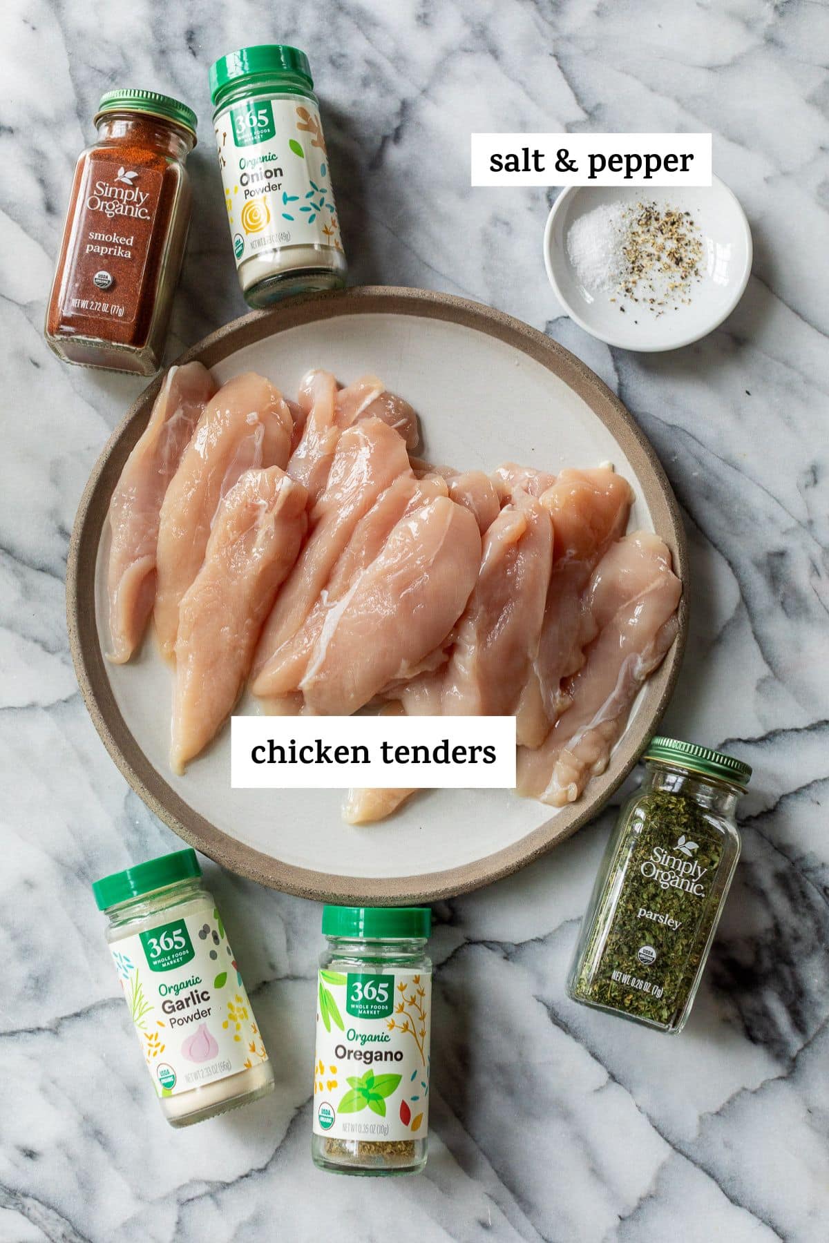 ingredients for baked chicken tenders in individual plates and containers with labels.