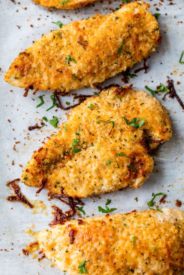 baked parmesan chicken breasts on a baking sheet