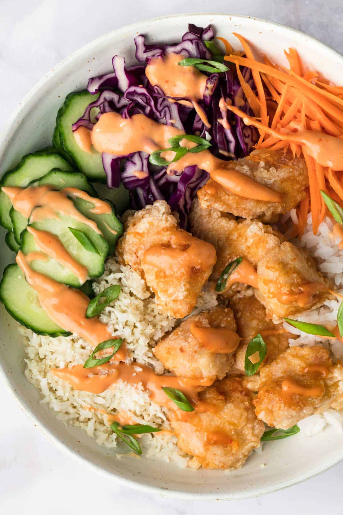 overhead view of a bang bang chicken bowl.
