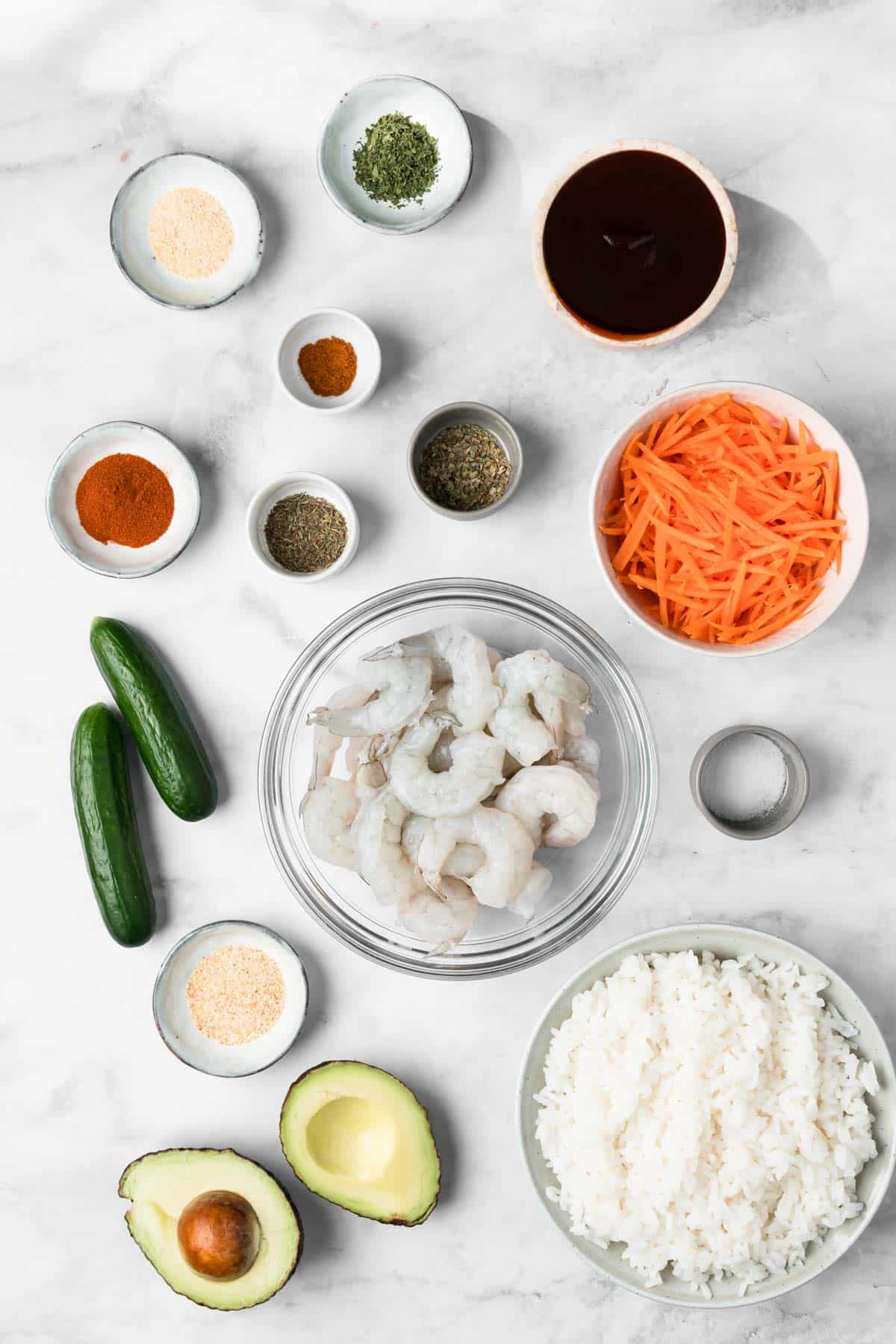 overhead view of the ingredients for BBQ shrimp bowls in individual bowls.