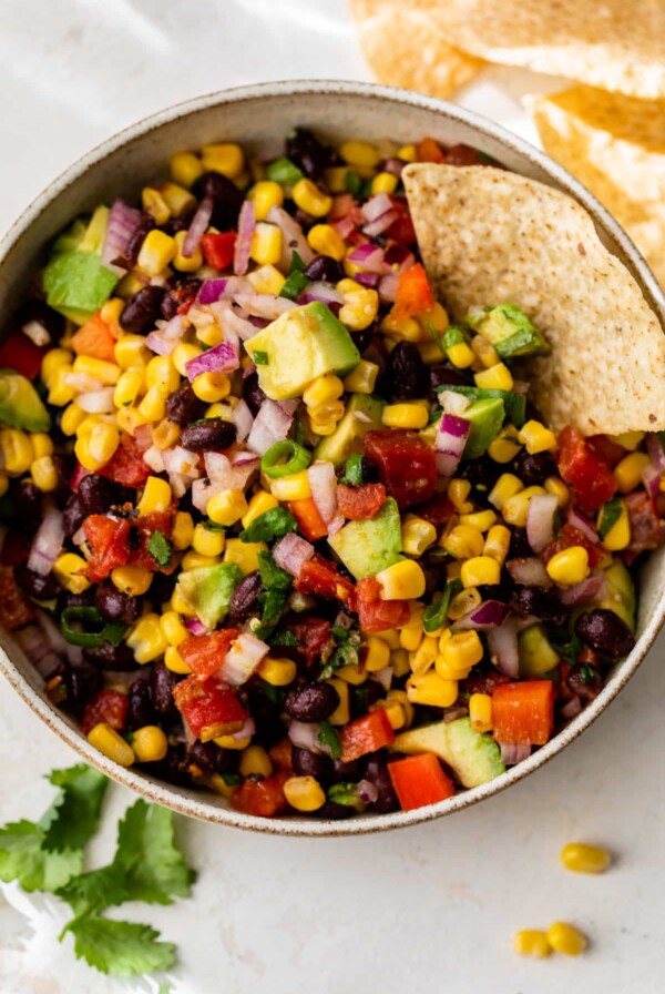 black bean corn salsa in a bowl with a tortilla chip