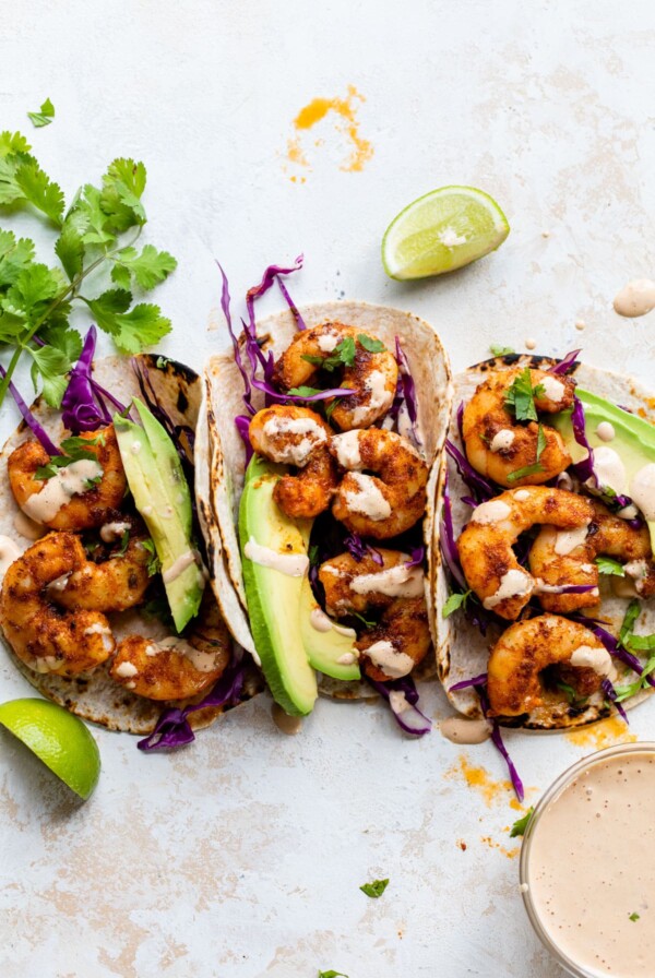 three blackened shrimp tacos with chipotle aioli on top