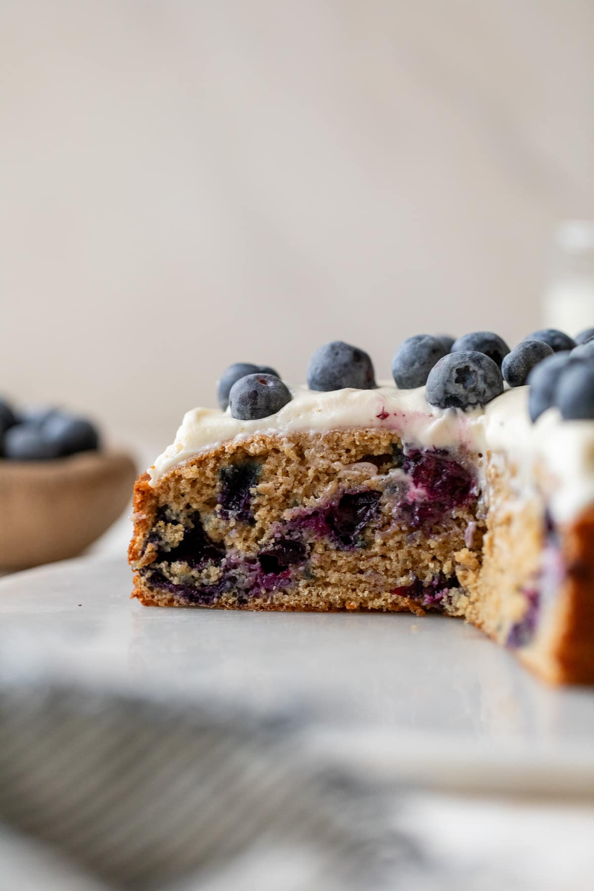 side view of blueberry cake with a slice taken out