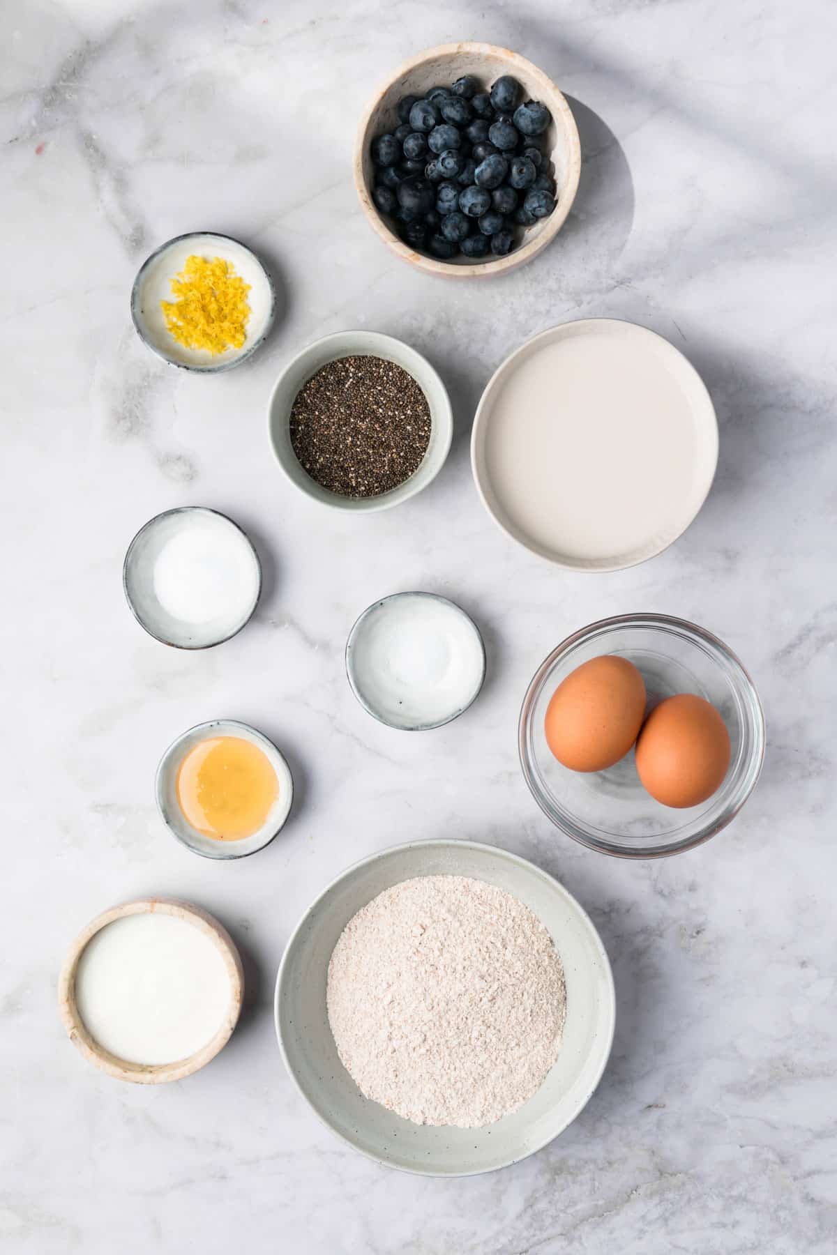 overhead view of the ingredients for chia seed pancakes in individual bowls.