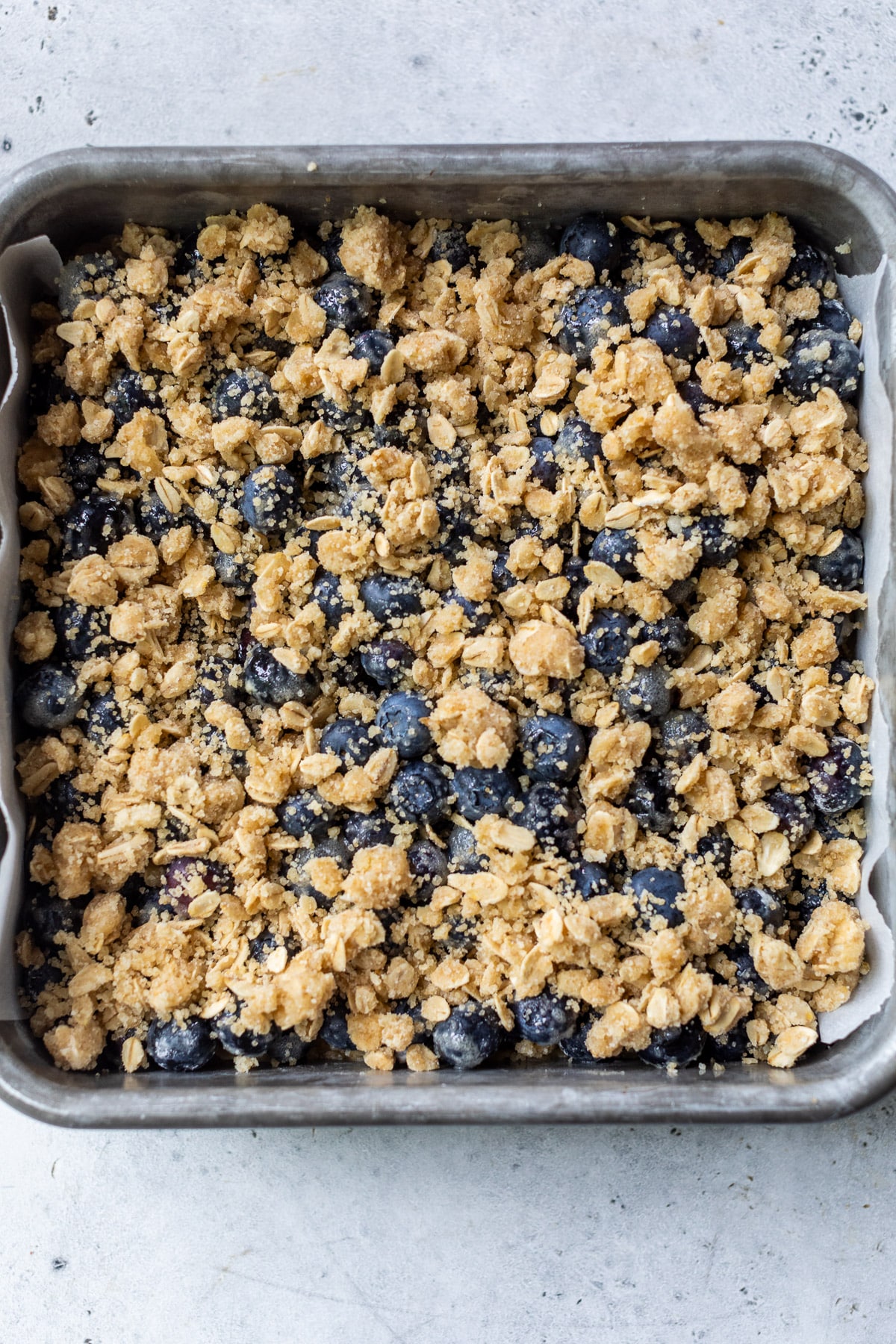 unbaked blueberry pie bars in a baking dish.