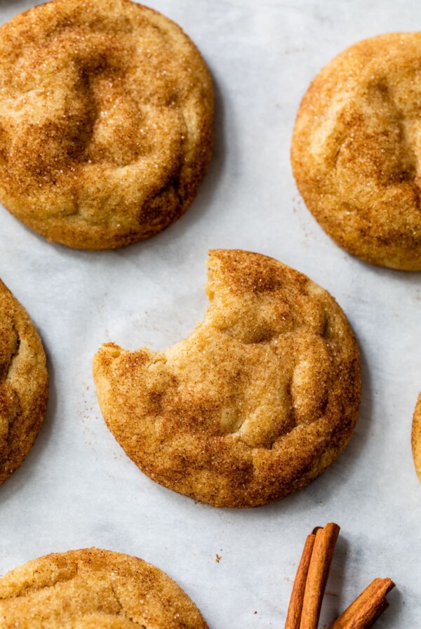 overview of brown butter snickerdoodles with a bite taken out of a cookie