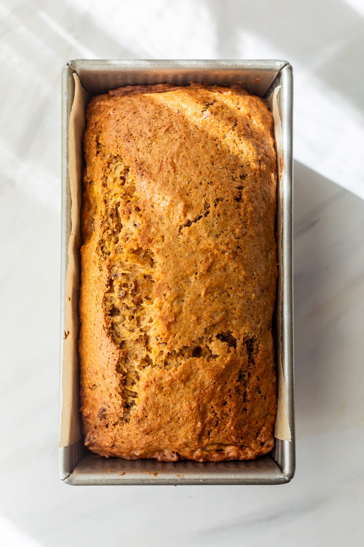 baked butternut squash bread in a loaf pan.