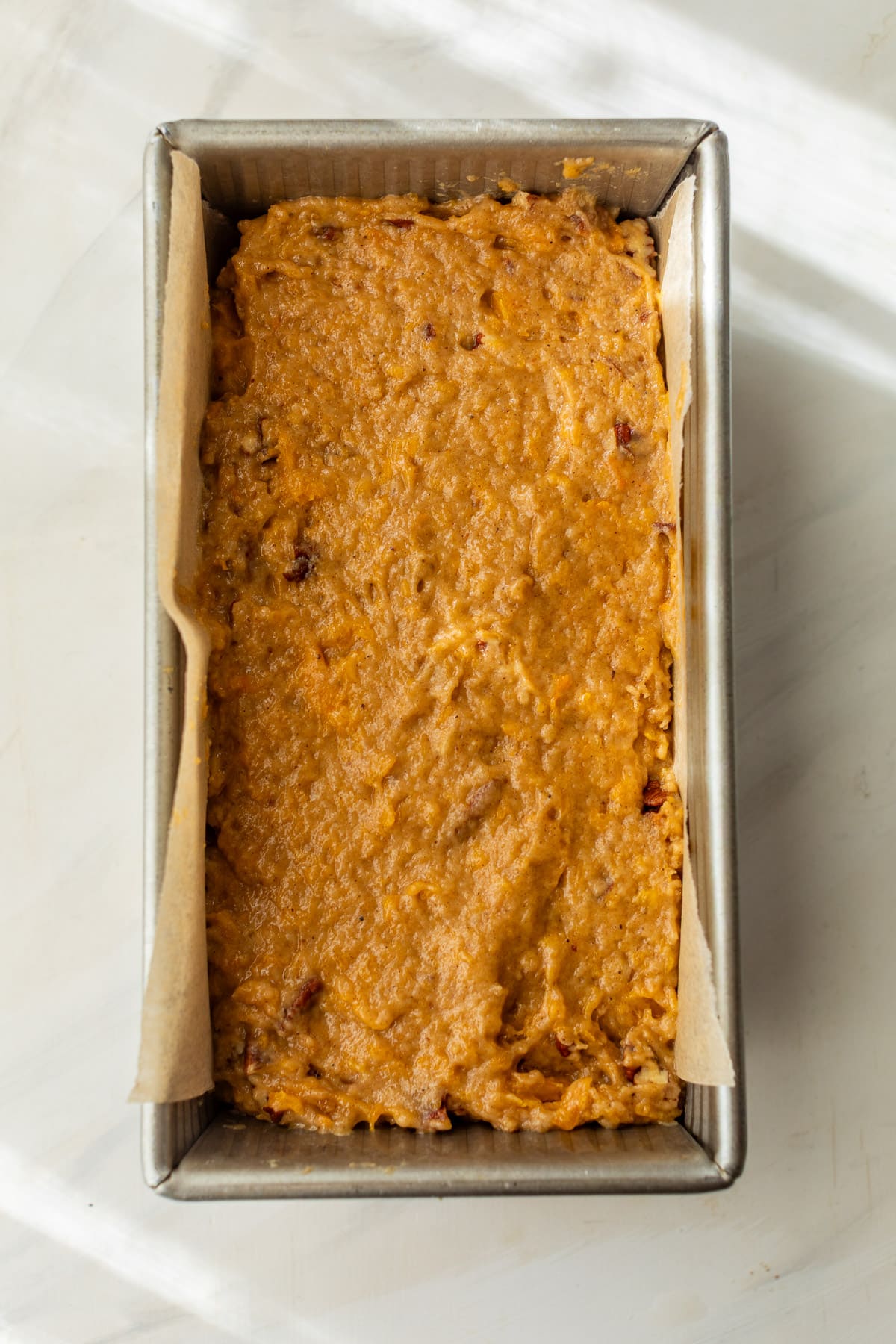 the batter for butternut squash bread in a loaf pan.