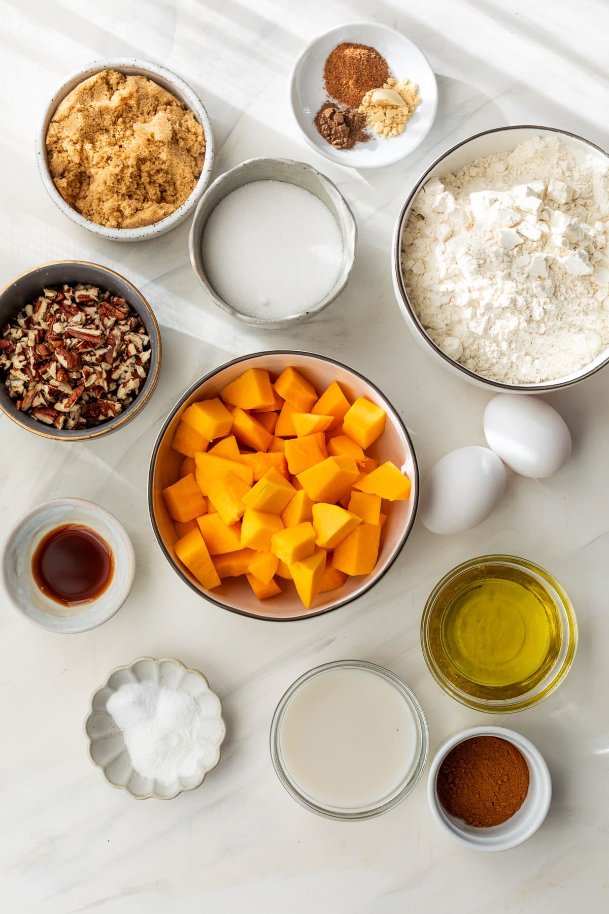 ingredients for butternut squash bread in individual small bowls.