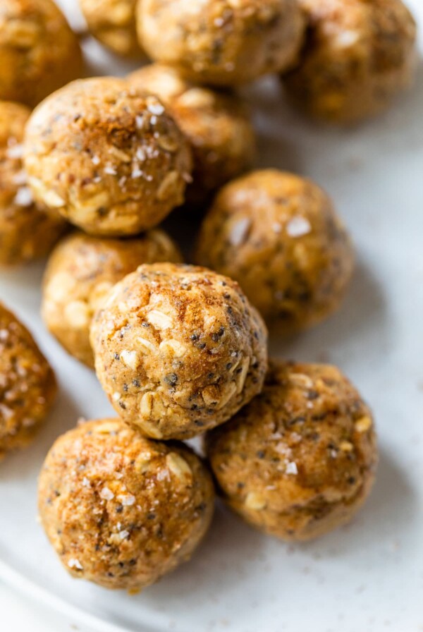 several energy balls made with nut butter and oats on a white plate