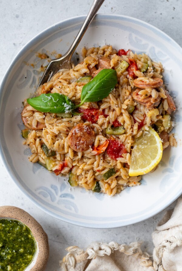 chicken sausage orzo in a bowl with a fork