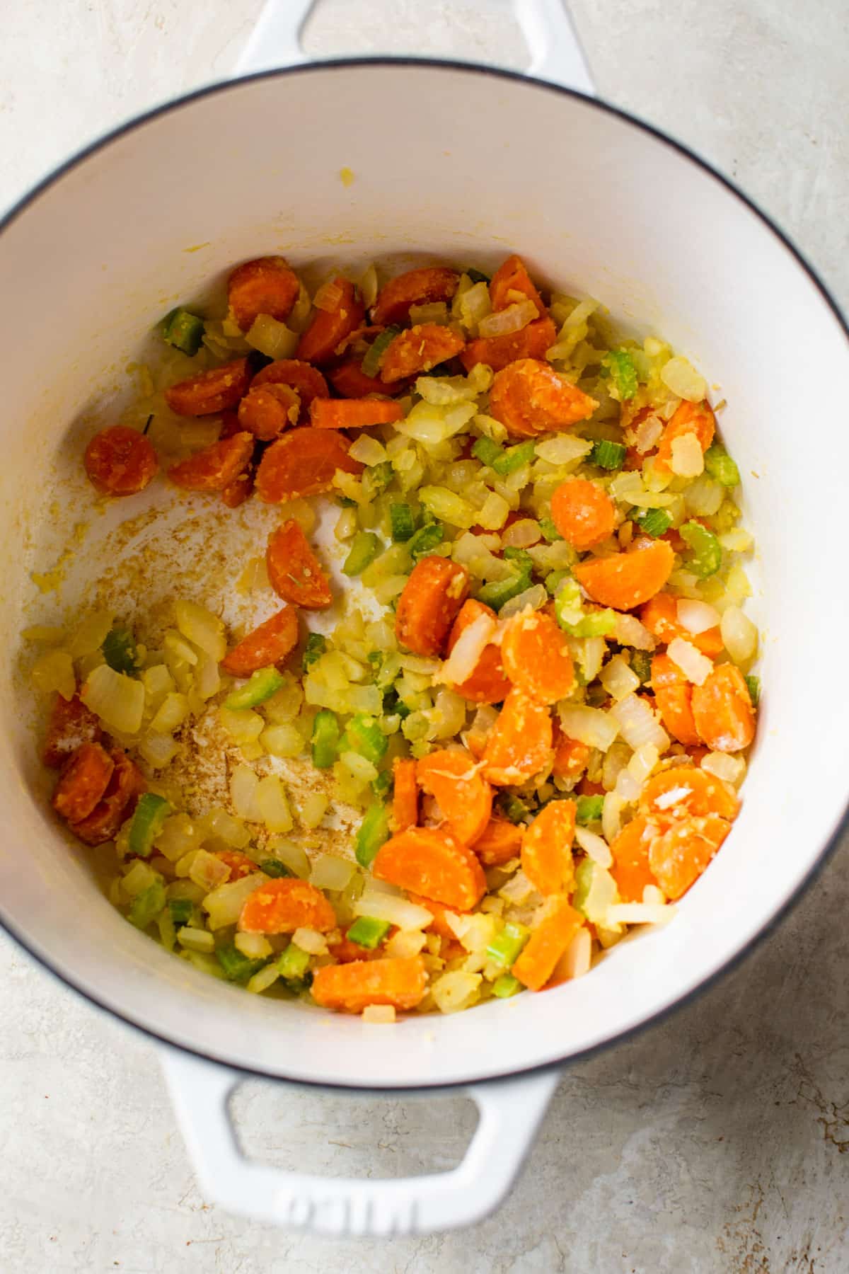 onion, carrots, and celery sauteing in flour in a dutch oven