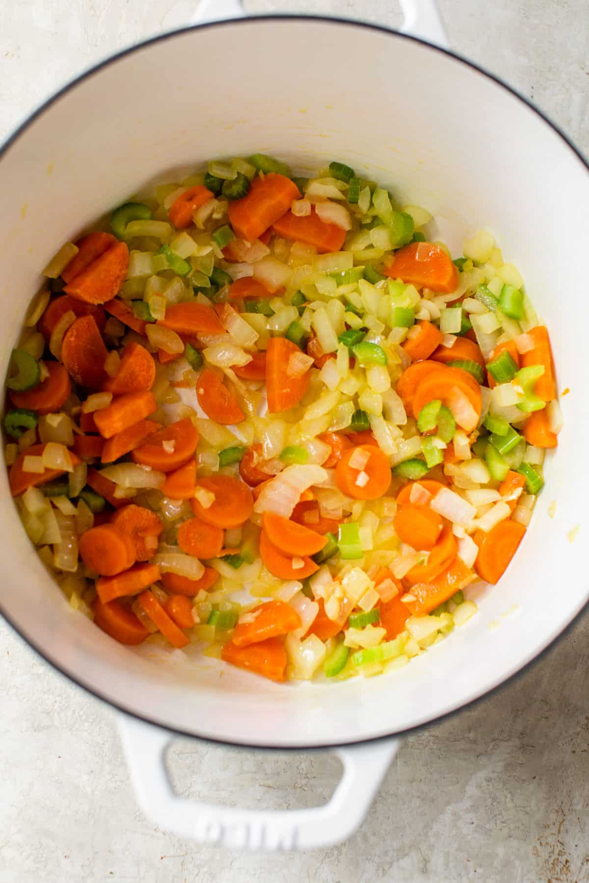 onion, carrots, and celery sauteing in a dutch oven