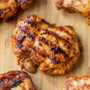 close up on Grilled Chipotle Chicken thighs on a bamboo cutting board.