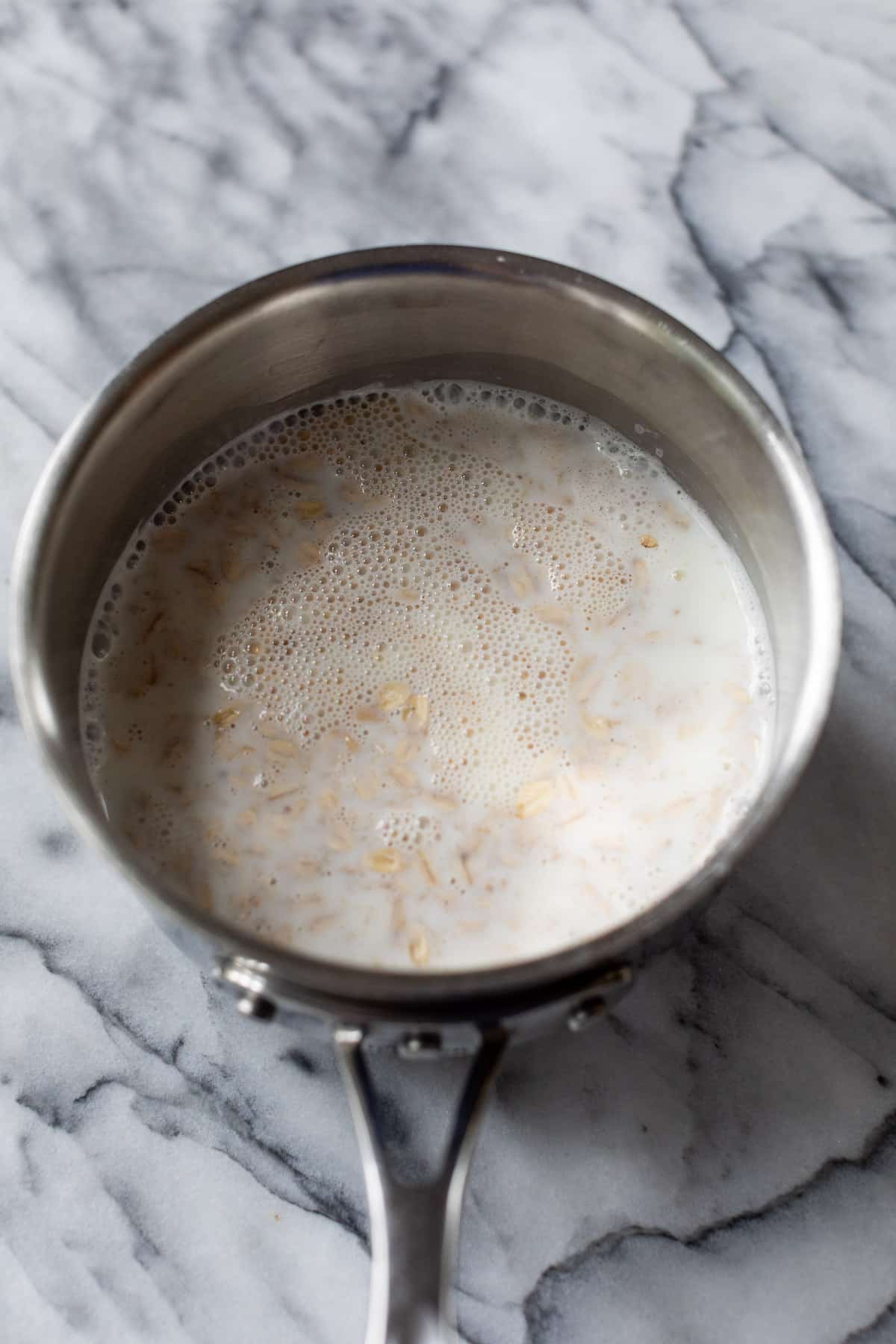oats in a milky liquid in a pot.