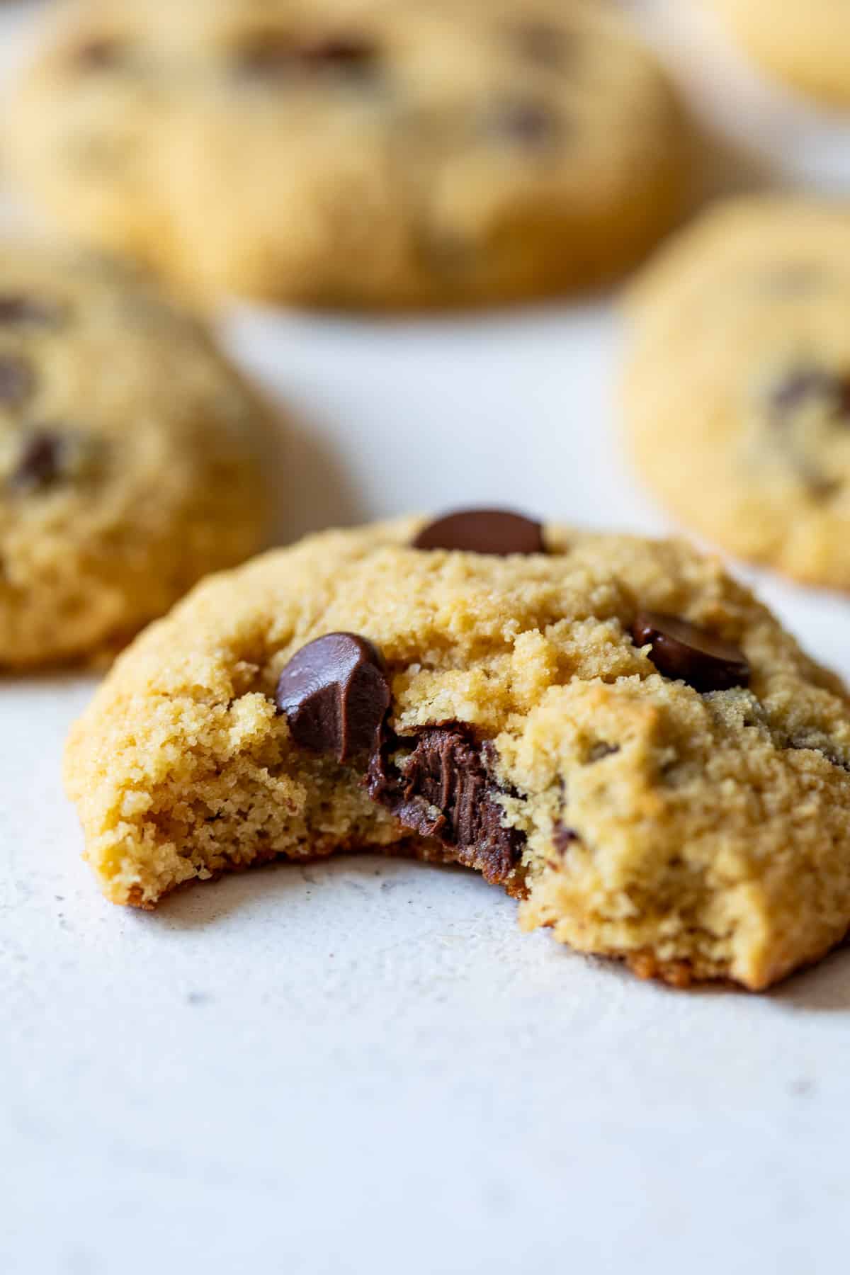 close up on a coconut flour cookie with a bite taken out of it.