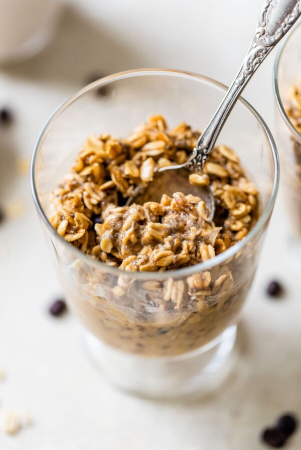 oats in a glass jar with a spoon in it