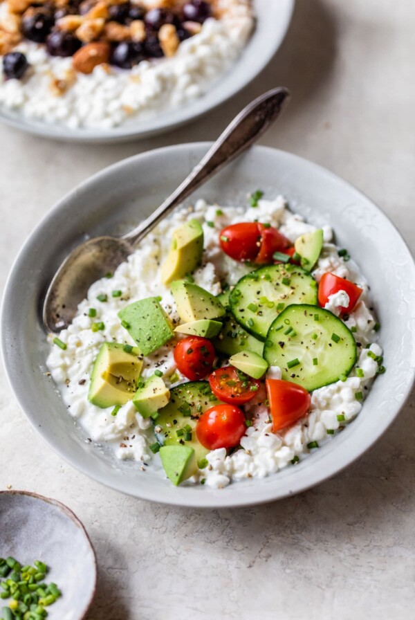 savory bowl of cottage cheese with tomatoes, cucumber and avocado
