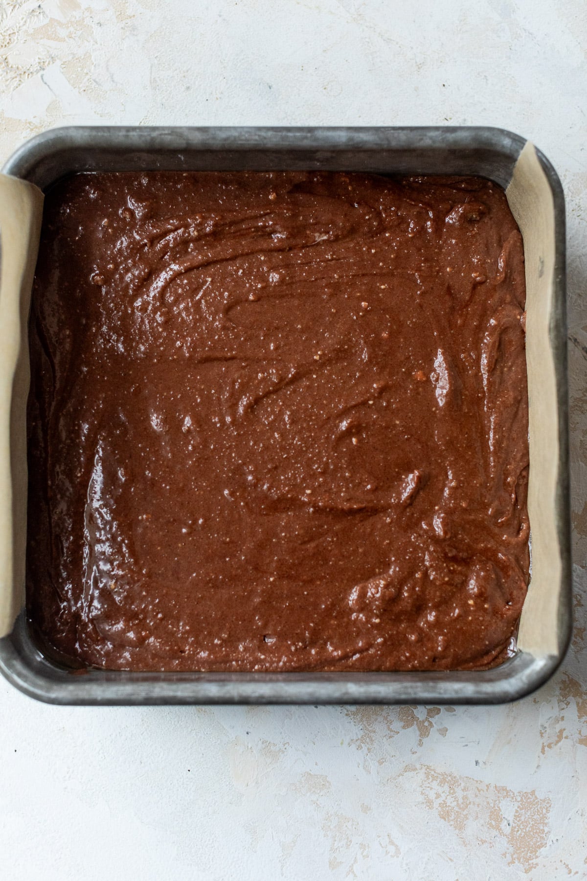 overhead view of cottage cheese brownie batter in a baking dish.