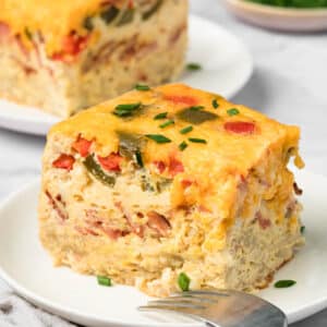 side view of a slice of crockpot breakfast casserole on a plate.