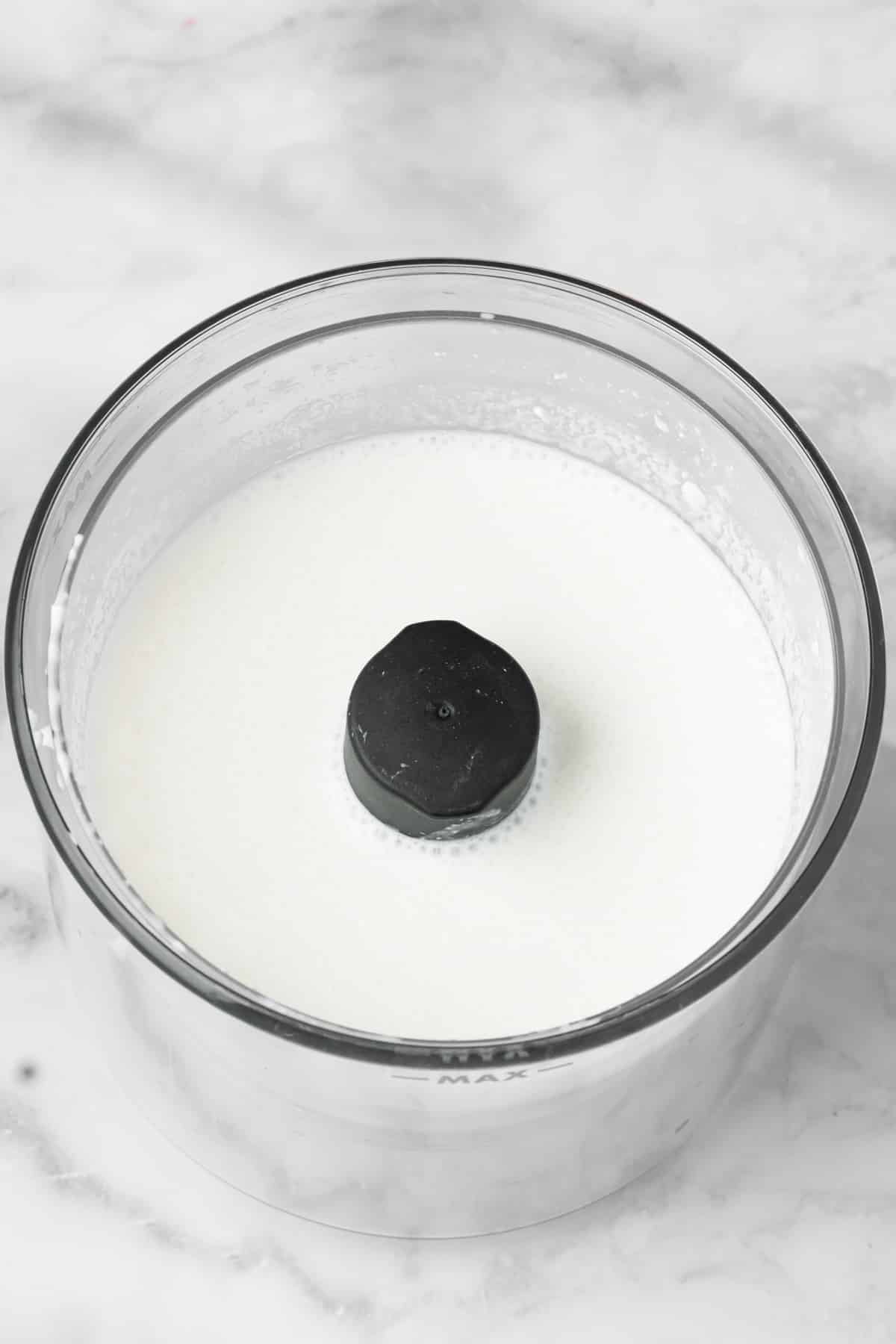 overhead view of blended cottage cheese and milk in a small blender.