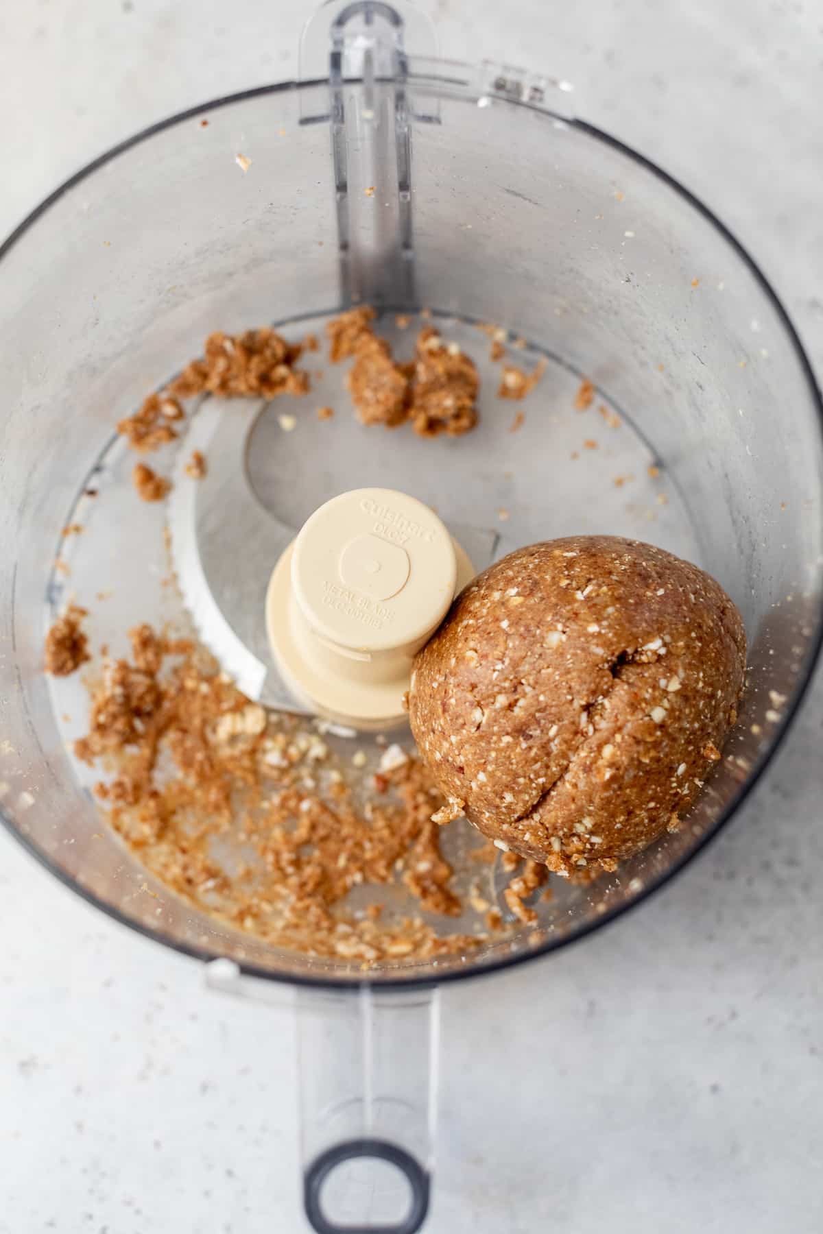 date energy ball ingredients mixed together in a food processor