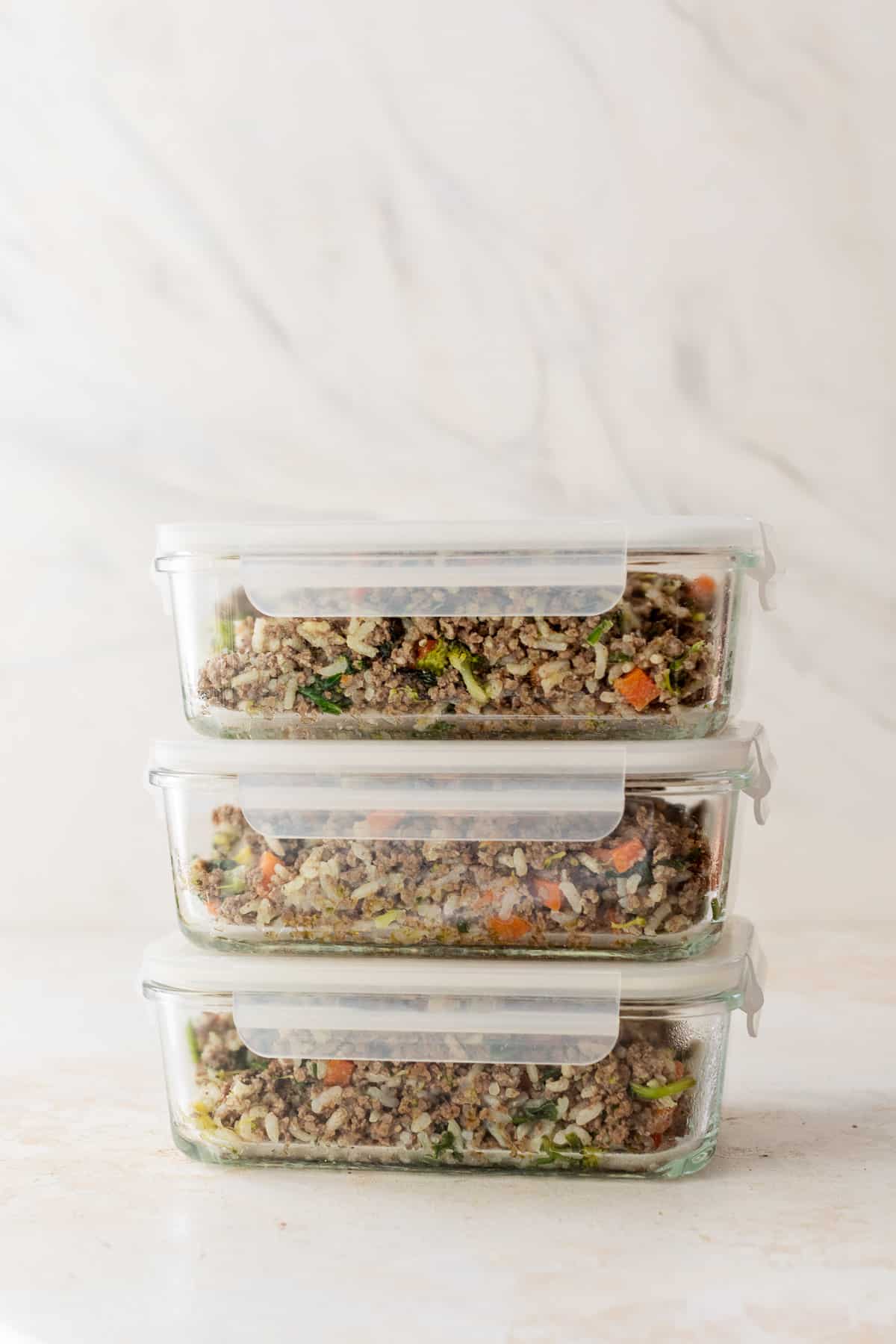 dog food in three glass meal prep containers