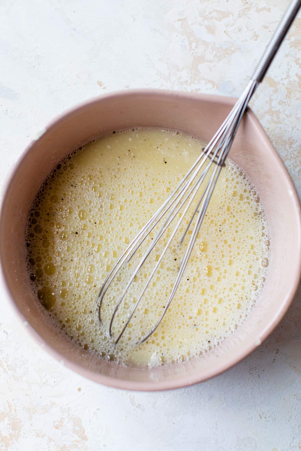 a bowl with egg whites, cottage cheese, and spices whisked together