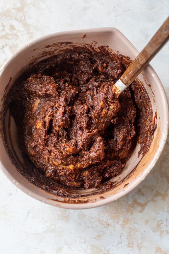 brownie batter in a bowl with a rubber spatula