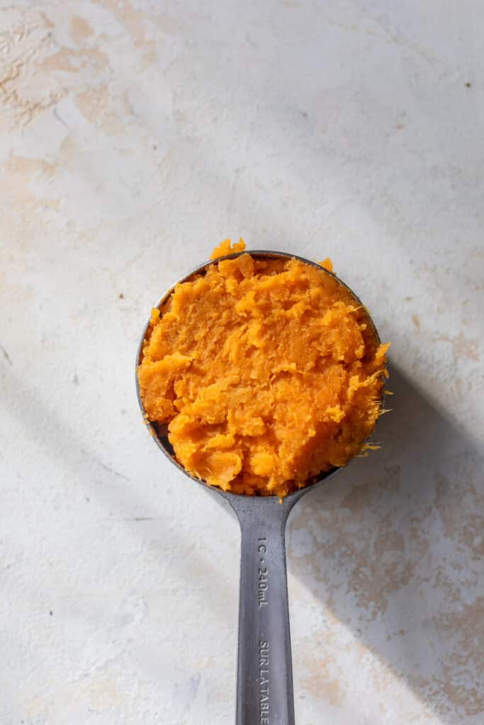 mashed sweet potato in a 1-cup measuring cup