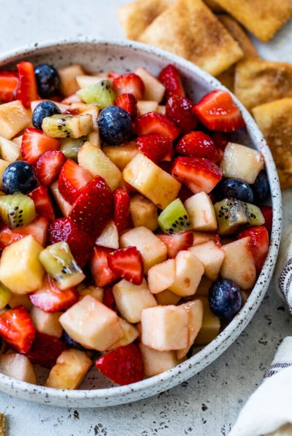 close-up of fruit salsa in a bowl with graham crackers and cinnamon pita chips off to the side