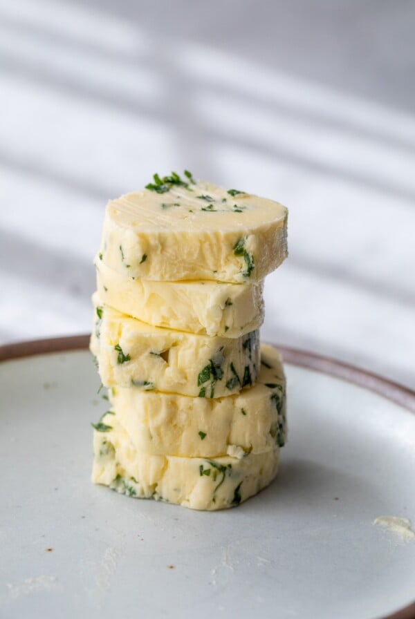 garlic butter rounds stacked on a plate