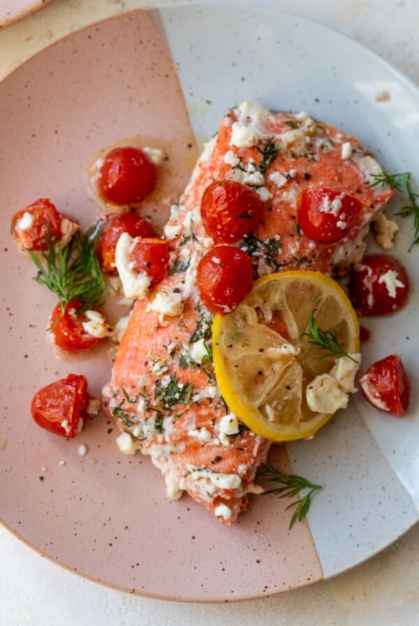 greek salmon on a plate with a lemon slice
