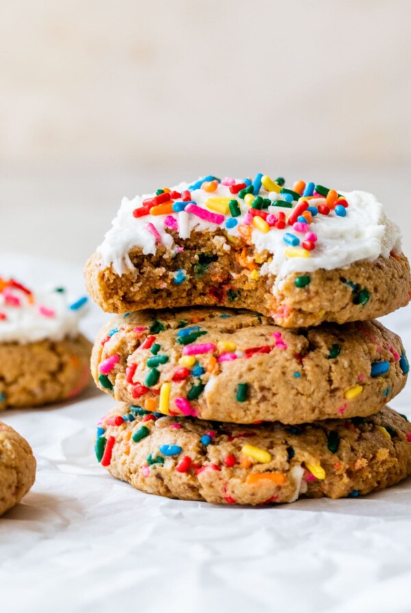 a stack of sprinkle cookies topped with icing