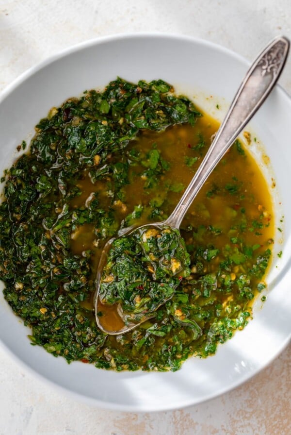 homemade chimichurri sauce in a bowl with a spoon