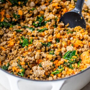 cooked meat and vegetables in a large white dutch oven