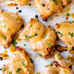 marinated boneless chicken thighs on parchment paper