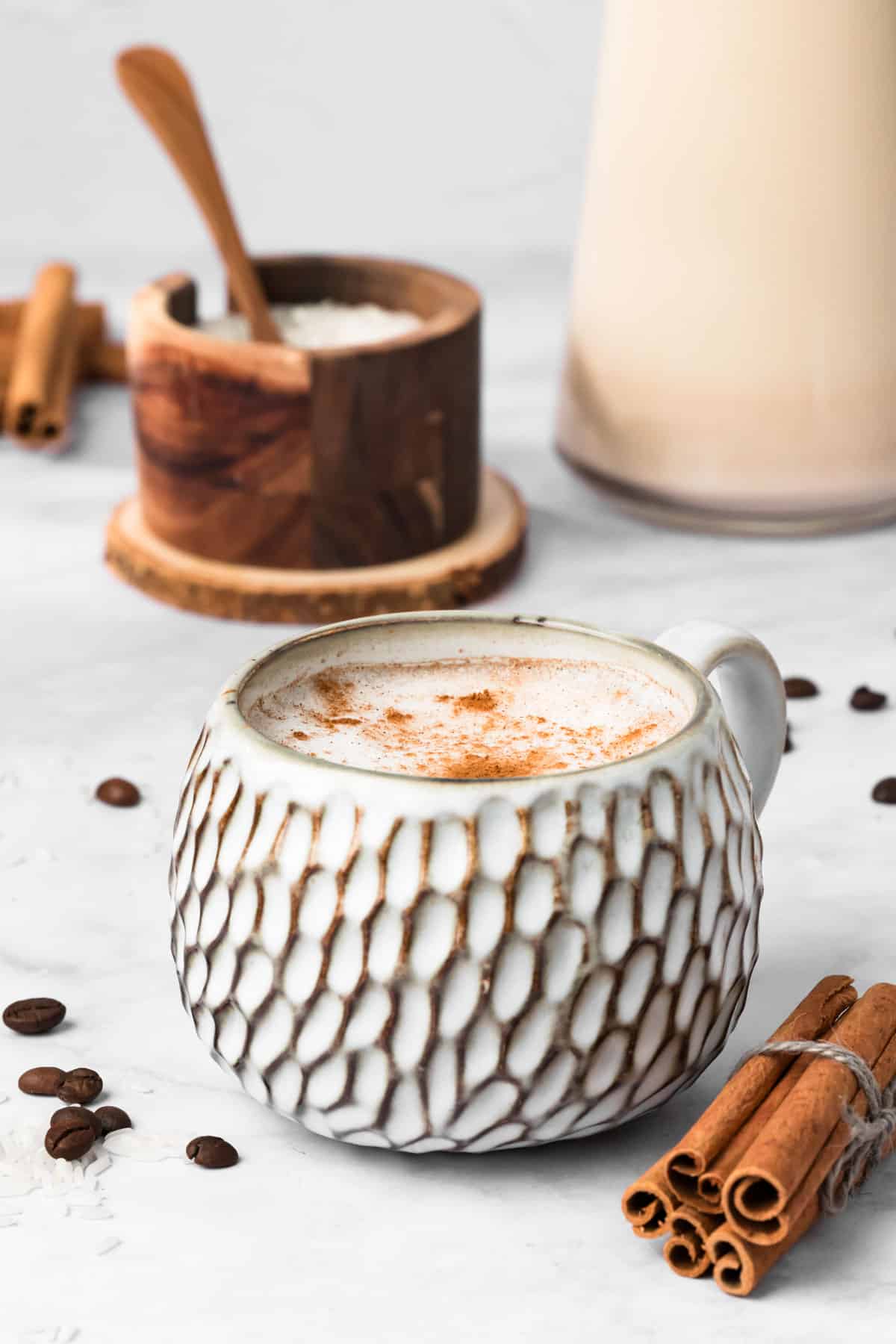 side view of a hot horchata latte in a white mug.
