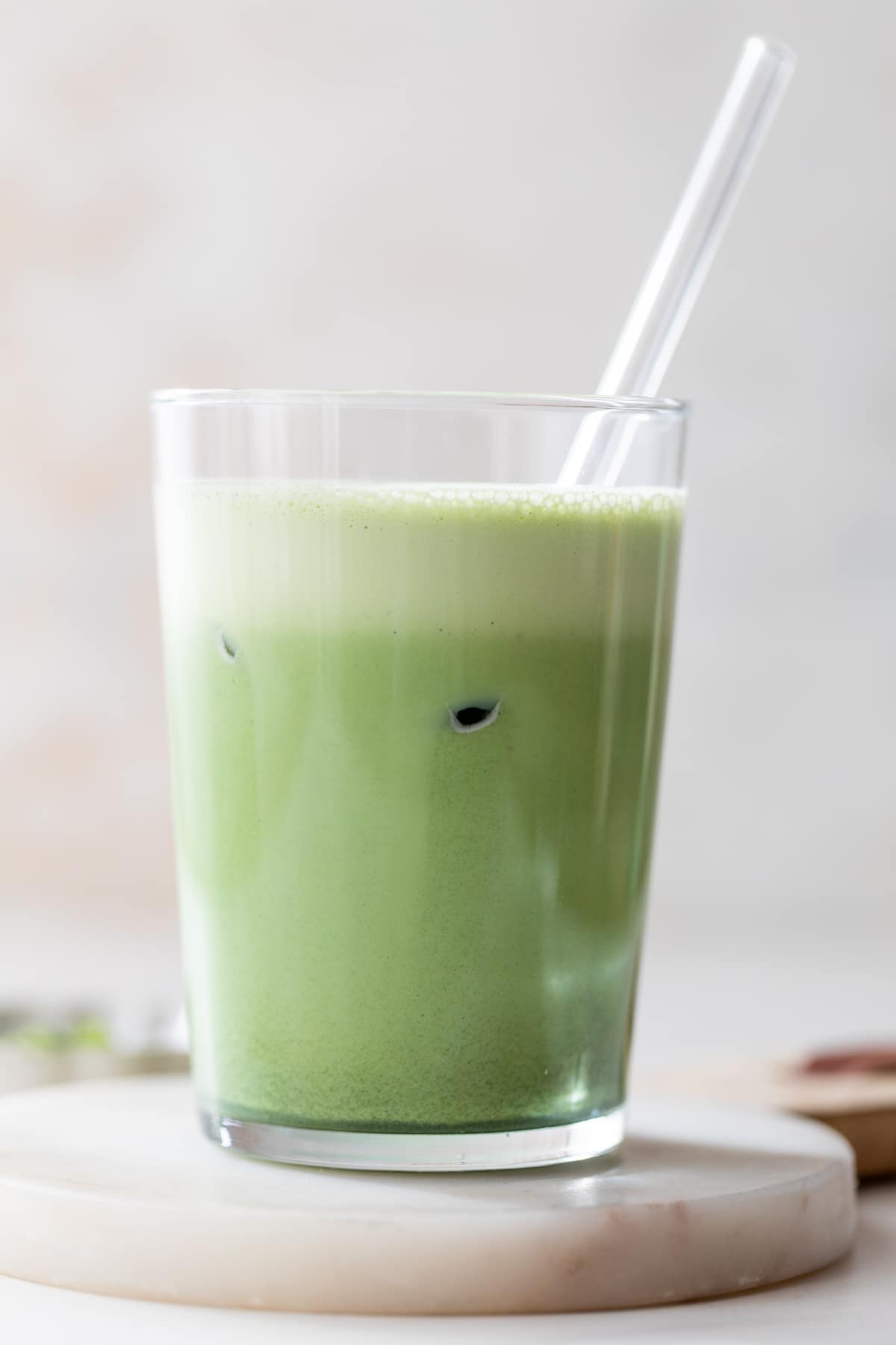 side view of an iced vanilla bean matcha latte