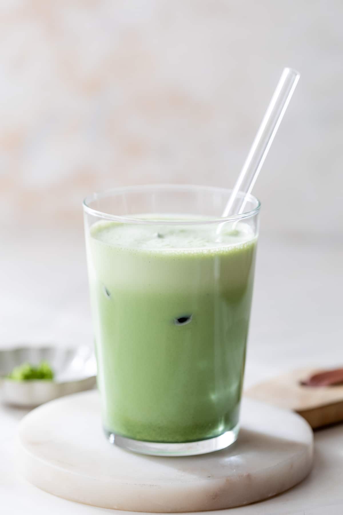 side view of an iced vanilla bean matcha latte