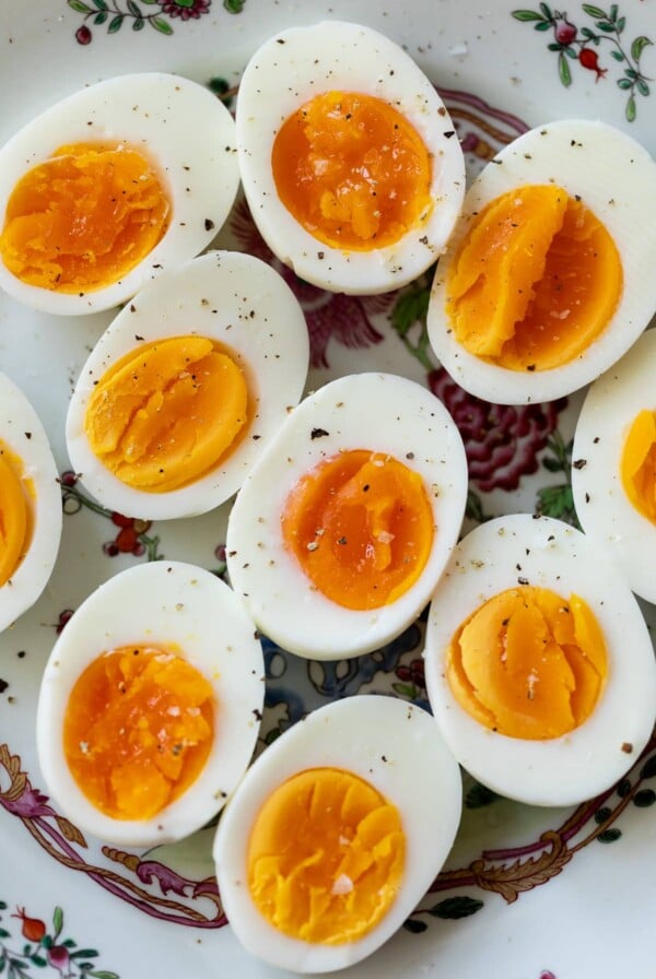 hard boiled eggs on a plate with ground pepper on top