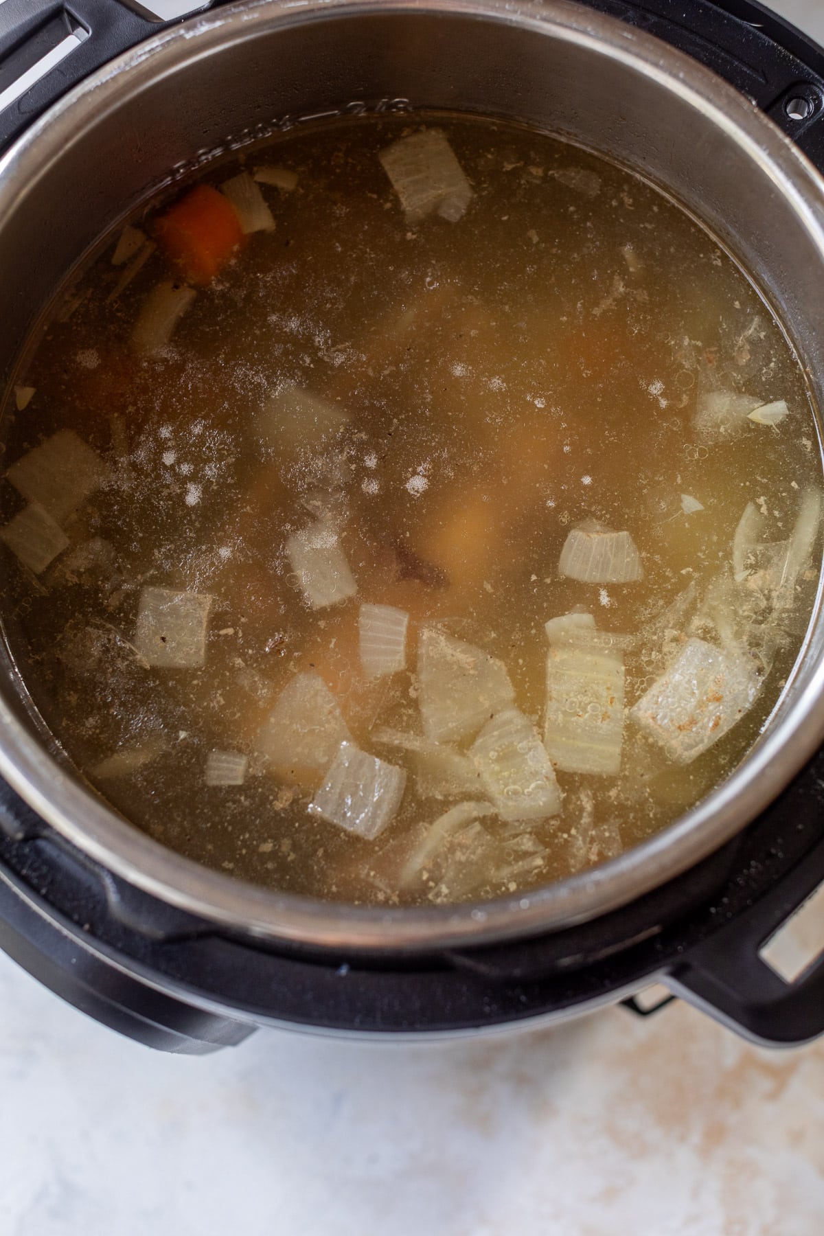 overhead view of cooked bone broth in an instant pot.