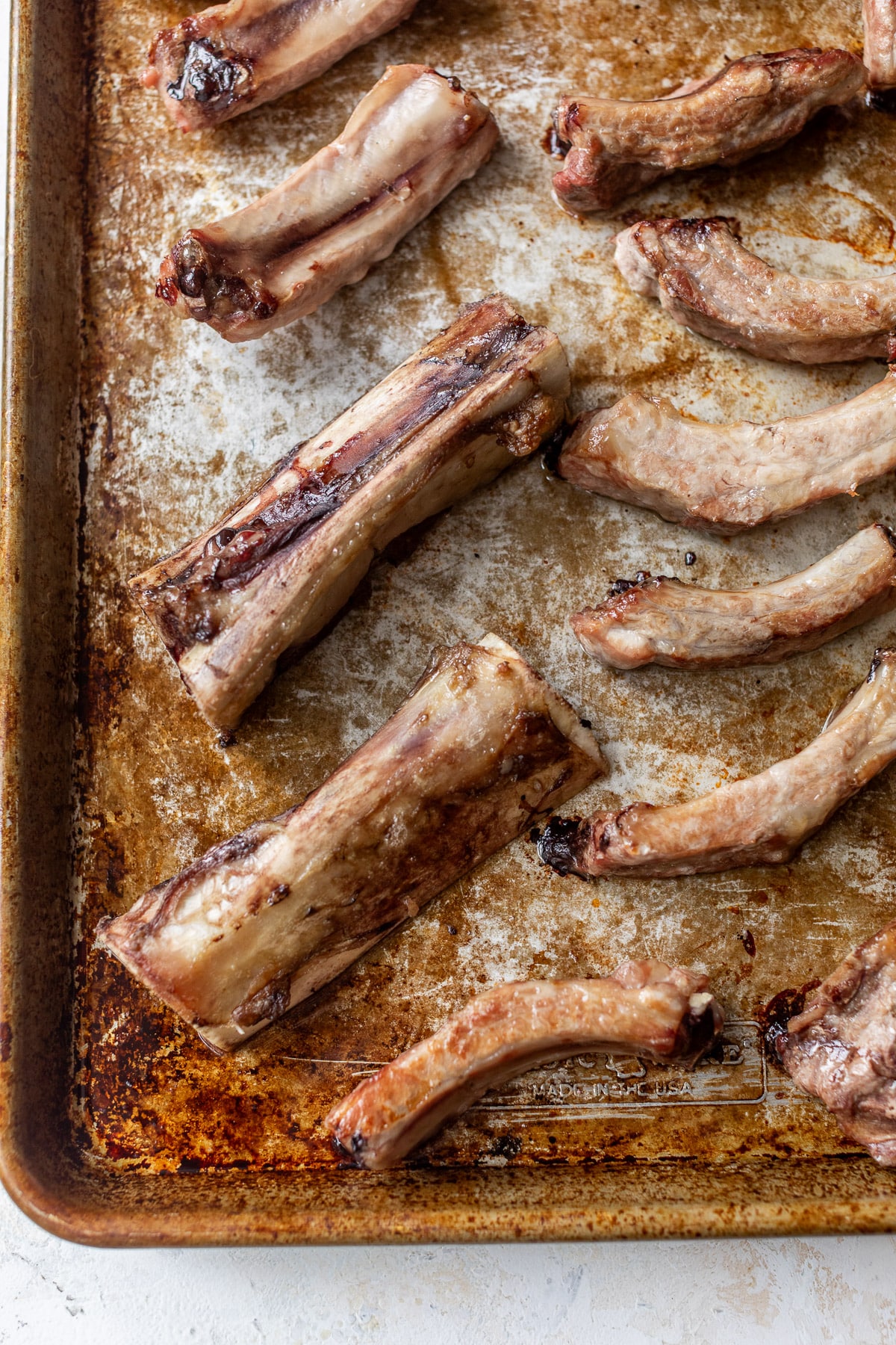 overhead view of beef bones on a sheet pan.