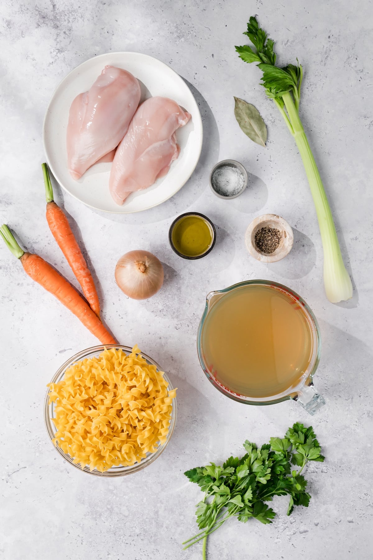 overhead view of the ingredients for Instant Pot chicken noodle soup in individual bowls.
