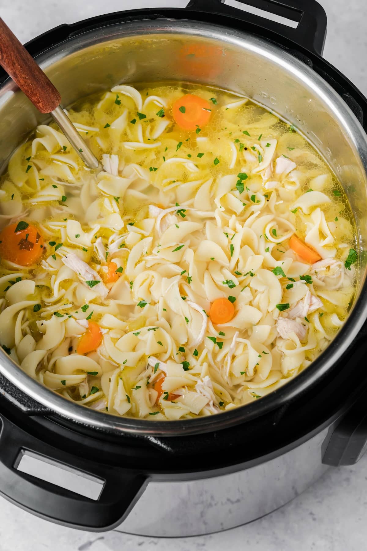 overhead view of Instant Pot chicken noodle soup in a pressure cooker.